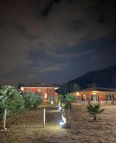 a house with lights in a yard at night at Villa Cilento Parking e Sosta Camper in Capaccio-Paestum