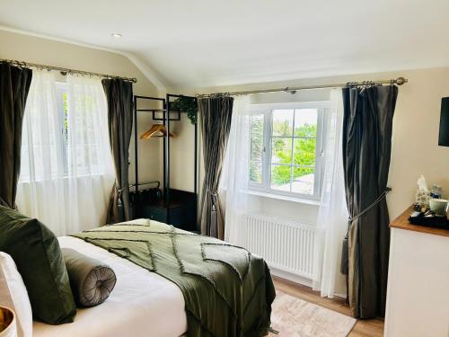 a bedroom with a bed and a window at Brackengarth House in Purdysburn