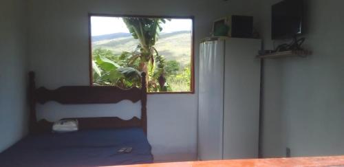 a room with a door with a window and a tree at Sítio Azevedo in Buenópolis