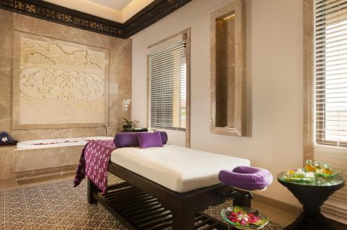 a room with a bed and a bath tub at RIMBA by AYANA Bali in Jimbaran