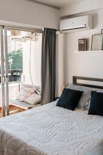 a bedroom with a large bed and a window at Home Corinto Beach terraza y piscina - Benalmadena Malaga in Benalmádena