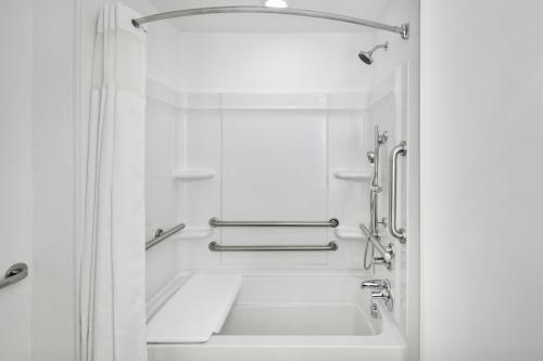 a white bathroom with a tub and a sink at StudioRes by Marriott Columbia Harbison in Columbia
