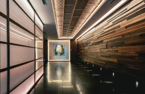 a hallway in a building with a painting on the wall at Noku Kyoto in Kyoto