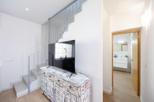a living room with a staircase and a television at Blue Haven by Fidalsa in Catral