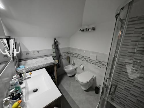a bathroom with a toilet and a sink and a shower at Attico Sole e Mare in Ventimiglia