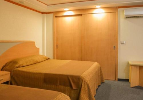 Postel nebo postele na pokoji v ubytování Hotel Milan CDMX