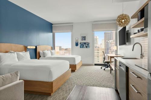 a hotel room with two beds and a kitchen at Element by Marriott New Orleans Downtown in New Orleans