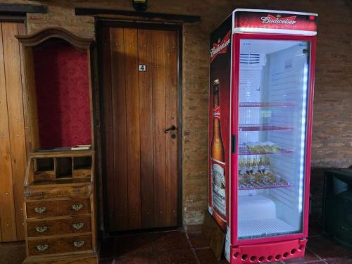 a cocacola refrigerator with a bottle of beer in it at Cabañas Lodge Angirú in Goya