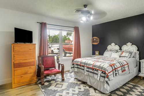 a bedroom with a bed and a chair and a window at Centrally Located Eagle Pass Home w/ Pool! in Eagle Pass