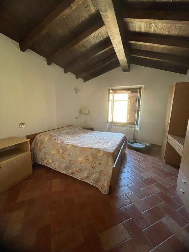 a bedroom with a large bed in a room at Casina Ghiana in Zocca