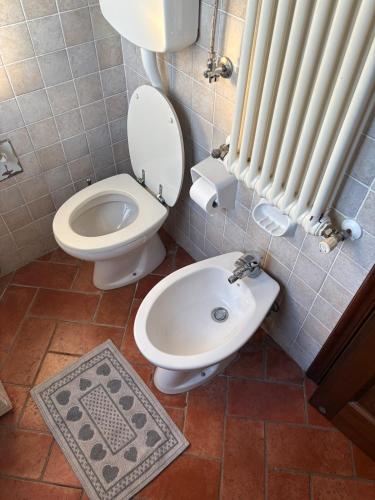 a bathroom with a toilet and a bidet at Casina Ghiana in Zocca