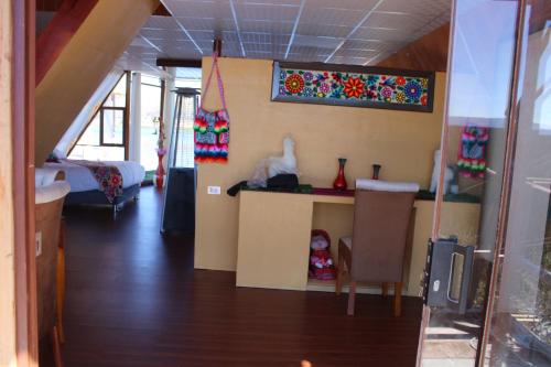 a room with a table and a bed in a room at Titicaca Mia Lodge Perú in Puno