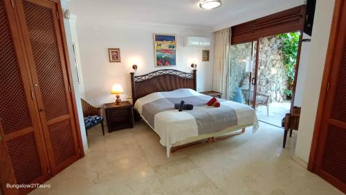 a bedroom with a bed and a door to a patio at Bungalow 21 Tauro in La Playa de Tauro