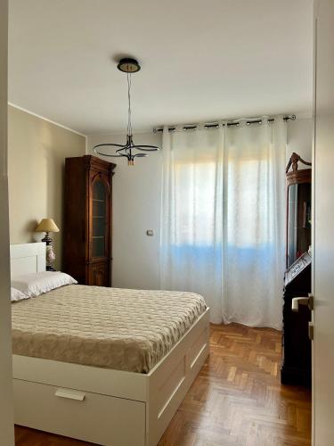 a bedroom with a bed and a ceiling fan at Camera da letto in Angolo di Pace in Grugliasco