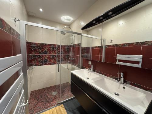 a bathroom with a sink and a glass shower at Harizou - Chalet & Piscine Intérieure in Saint-Pierre-la-Vieille