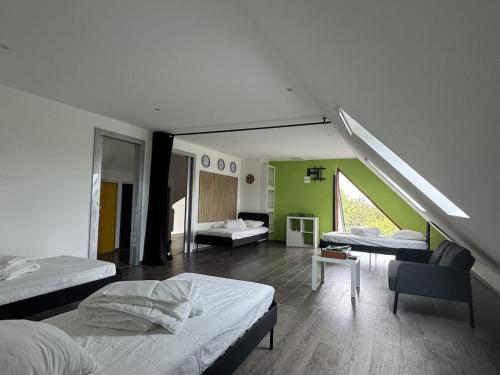a bedroom with two beds and a living room at Harizou - Chalet & Piscine Intérieure in Saint-Pierre-la-Vieille