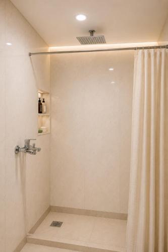 a shower with a shower curtain in a bathroom at The Onyx by 7 Valleys in Islamabad