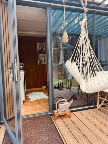 a porch with a hammock on a house at Zakątek Młynarza in Pruszkowo