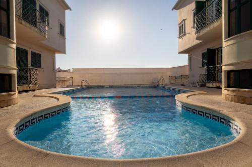 a swimming pool in the middle of a building at BE LOST - Guest House in Pedra Do Ouro