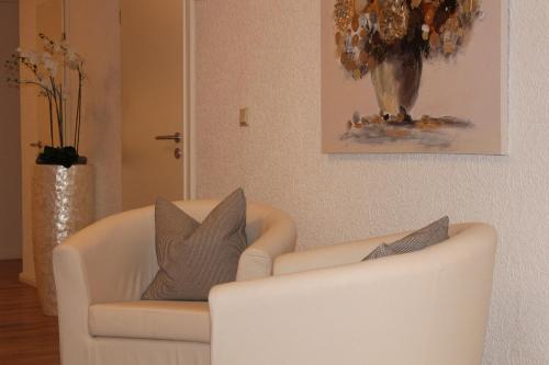 a white couch with two pillows on it in a living room at Dötlinger Hof in Dötlingen