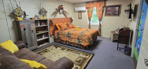 a living room with a bed and a couch at Medley Manor in East Peoria