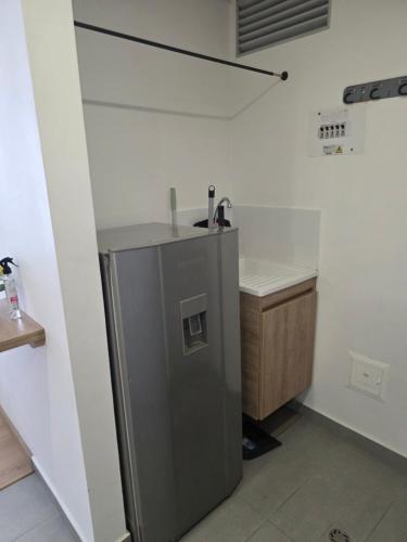 a kitchen with a sink and a refrigerator at Cozy studio apartment with a privileged view in Manizales