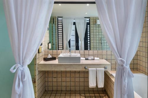 a bathroom with a sink and a mirror at Ocean Coral & Turquesa All Inclusive in Puerto Morelos