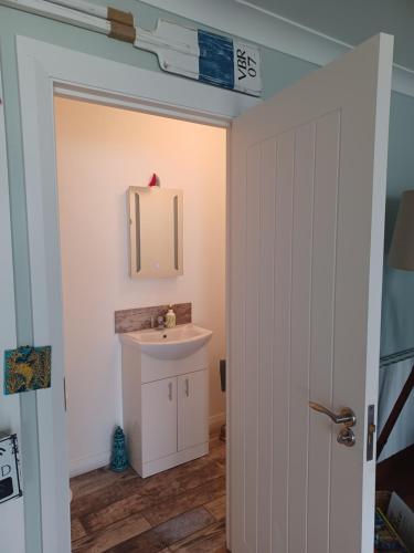 a bathroom with a sink and a mirror at The Boathouse in Ballycotton