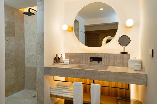 a bathroom with a sink and a mirror at Kimpton Tres Rios - All Inclusive in Playa del Carmen