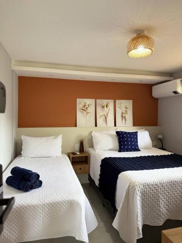 a bedroom with two beds with white sheets at Casinha de Aldeia in Aldeia Velha