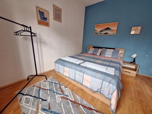 a bedroom with a bed with a blue wall at Atelier22 in Prilep
