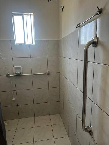 a bathroom with a shower with a glass door at Loft Pedra Branca - Unisul in Palhoça