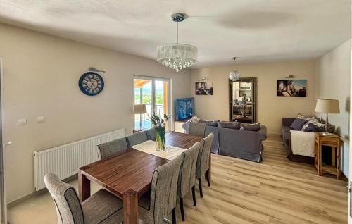 a dining room and living room with a table and chairs at Stunning Home In Sinj in Sinj