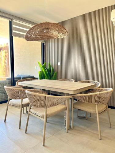 a dining room with a table and chairs at Oceanfront Paradise Family Friendly in Telchac Puerto