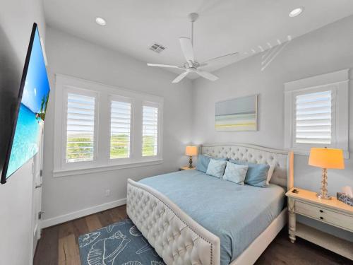 a bedroom with a bed and a ceiling fan at Luxury Beachfront Ocean Views Pool Access Sleeps15 in Bolivar Peninsula