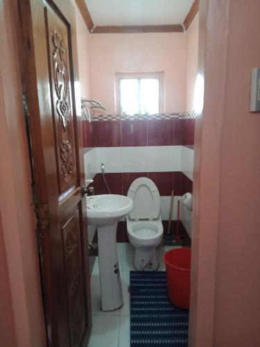a bathroom with a toilet and a sink at Ancestral BATO in Bato