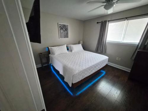 a bedroom with a bed with blue lights on the floor at Best location Cozy condo in Biloxi Beach in Biloxi