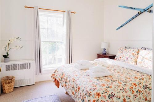 a bedroom with a bed with towels on it at Sweet Stowe Apartment in Stowe