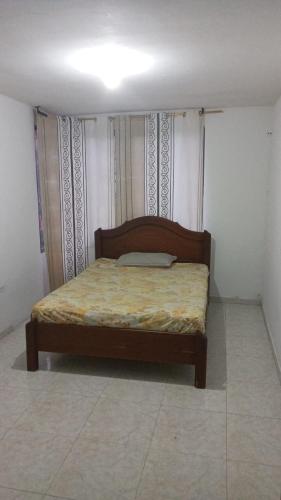 a bedroom with a bed in a room at LaHouse in Cali