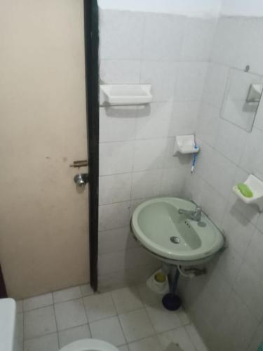 a bathroom with a sink and a toilet at LaHouse in Cali