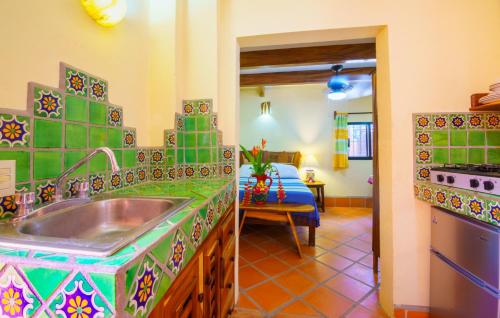 a kitchen with a sink in a room at Hotel Casamar Suites in Puerto Escondido