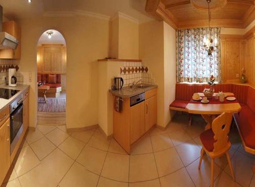 a kitchen with a table and a small table in it at Gästehaus Alpina in Maurach