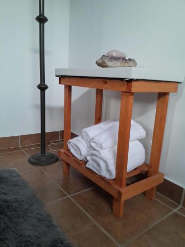 a table with a pile of towels on a shelf at Amaicha Luján in Luján