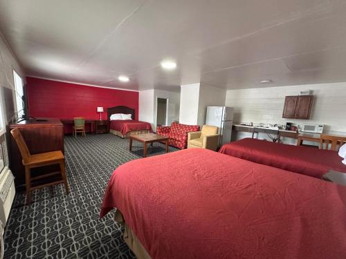 a hotel room with two beds and a kitchen at Rodeway Inn Flora in Flora