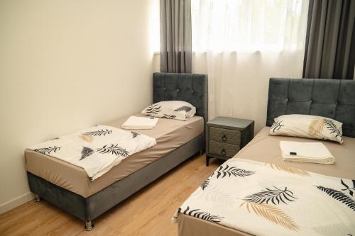 a room with two beds and a window at PIK Residence in Mostar