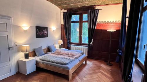 a bedroom with a bed and a large window at Zum Hölltor in Überlingen