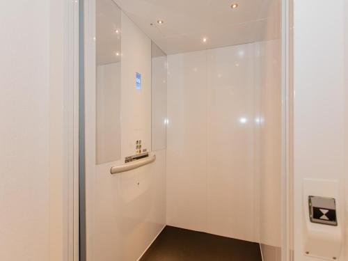 a bathroom with a white door with a sink at Das Rendlgut Top 3 in Lofer