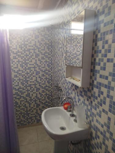 a bathroom with a sink and a mirror at Sierras Cosquin in Cosquín