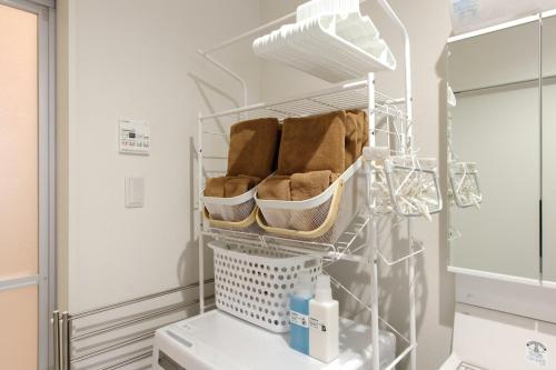 a laundry room with a drying rack and a washing machine at AsobiStay児玉藤 in Nagoya
