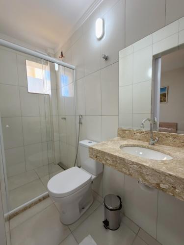 a bathroom with a toilet and a sink and a shower at Hotel C Diamantina in Vitória da Conquista